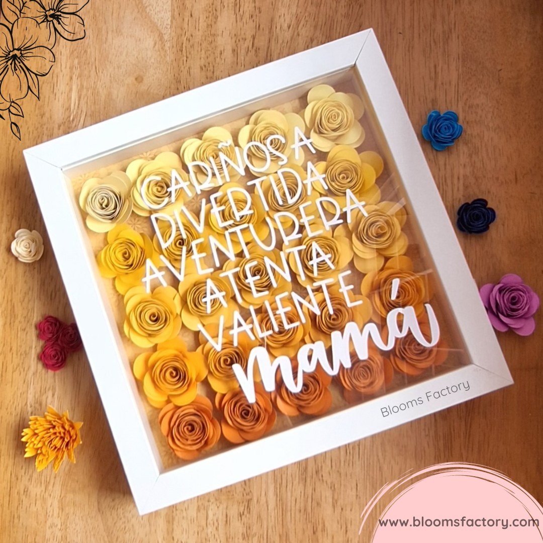 Este detalle único es un hermoso arreglo de flores de papel en una caja de sombras, ideal para regalar a mamá. Esta caja contiene flores de papel amarillas y naranjas, dispuestas con elegancia y delicadeza. La tapa transparente tiene el texto “Mamá”, acompañado de adjetivos que la definen: cariñosa, divertida, aventurera, atenta y valiente.Es perfecta para colocarla en cualquier rincón de la casa y recordarle lo mucho que la quieres. ¡Sorpréndela con este regalo especial!